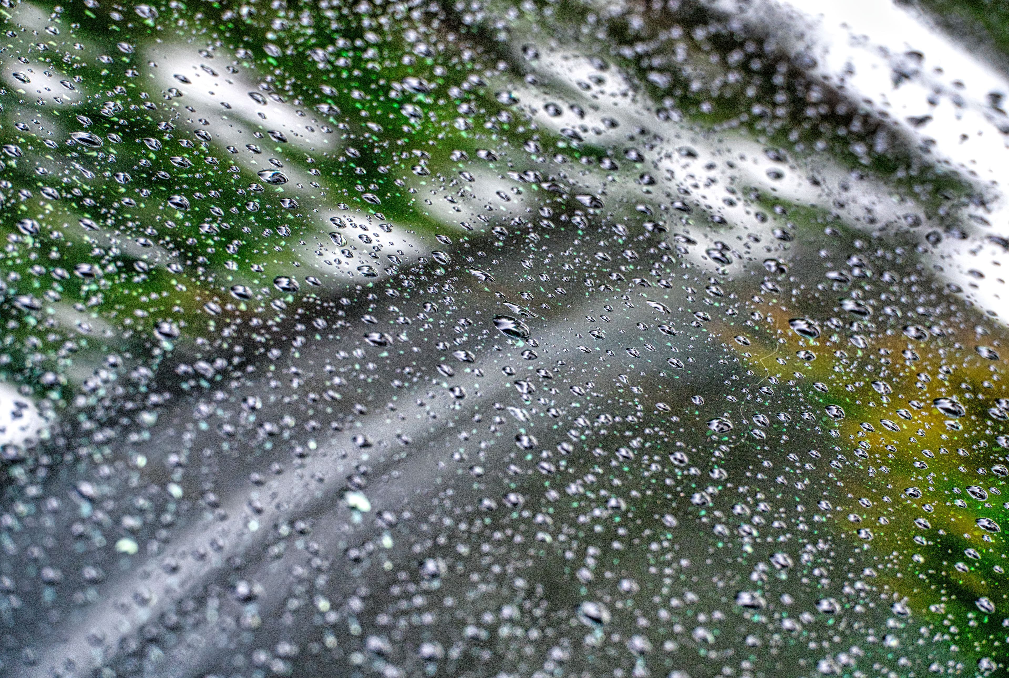 Close-up of raindrops on window, showcasing nature's beauty in Banten, Indonesia.
